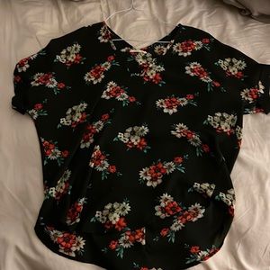 Black floral top, cropped in the front and long in the back